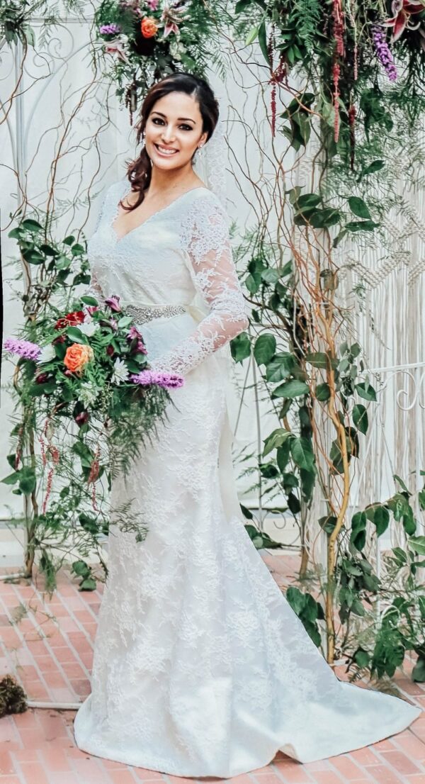 A bride wearing a white long-sleeved bridal gown (scaled)