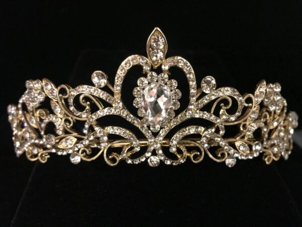 A gold and crystal tiara on a black background.