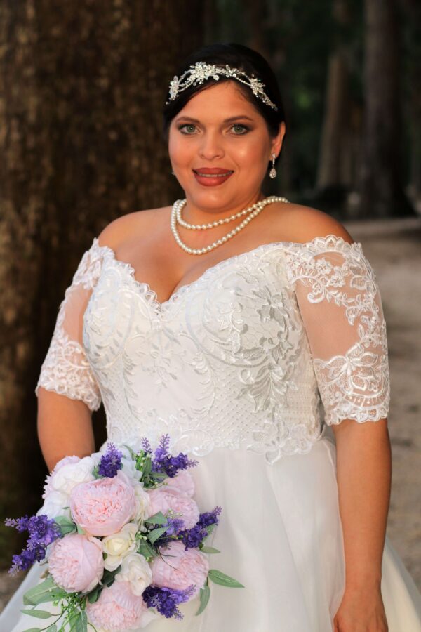 A woman in a wedding dress posing for a picture.