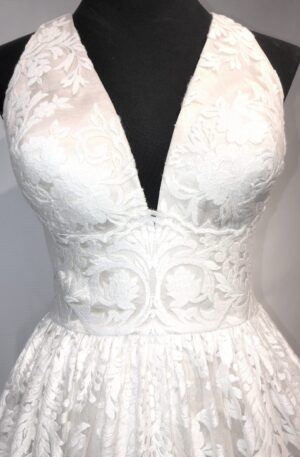A white lace wedding dress on a mannequin.