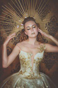 Gold couture dress with halo-like crown
