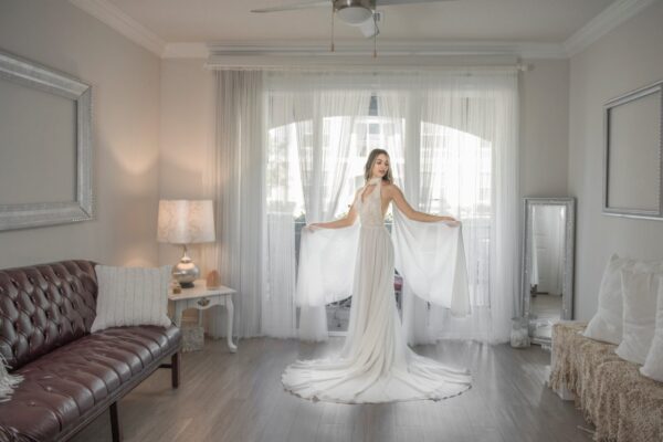 A bride in a Halter Top Chiffon Wedding Dress standing in a living room.