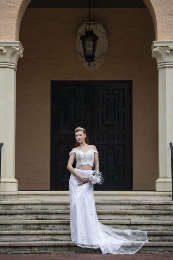 A bride in a Wedding Dress Ball Gown Marie is standing on the steps of a building.