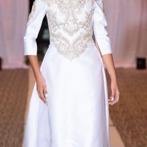 An off-shoulder, long-sleeved wedding dress