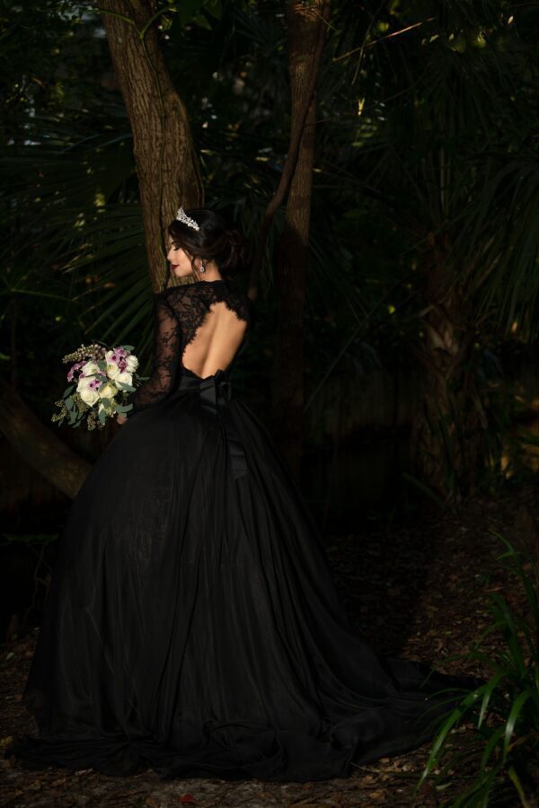 A black wedding dress with lace long-sleeves and a round opening at the back
