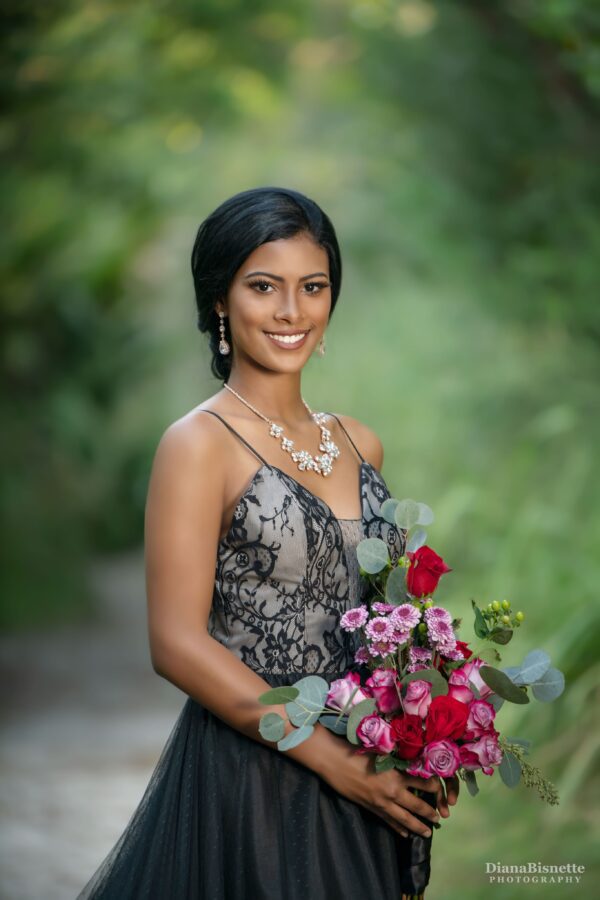 bride standing with a beautiful black wedding dress with a colorful bridal bouquet, custom made bridal gown