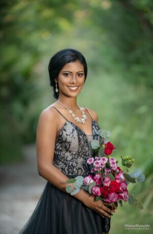 A bride in a black dress holding a bouquet of flowers from the Black Wedding Dress Collection in Orlando Florida.