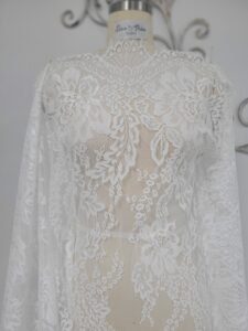 A white lace dress on a mannequin.