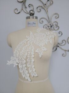 White lace applique on a mannequin.