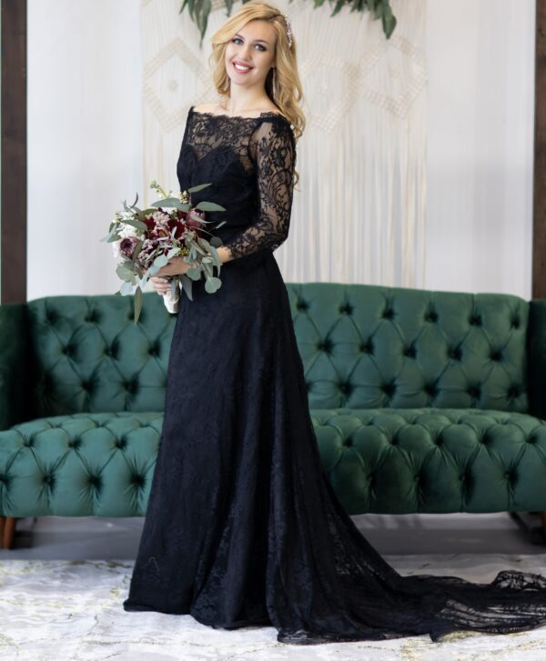 bride wearing a black wedding dress, with long lace sleeves, off the shoulder, fit and flare black lace skirt