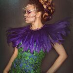A green and purple dress with purple feathers