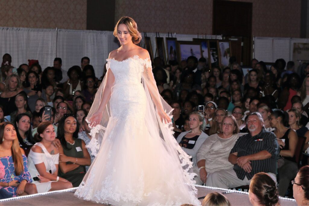 A Florida woman is gracefully strutting down the runway showcasing an exquisite wedding dress designed with utmost care.