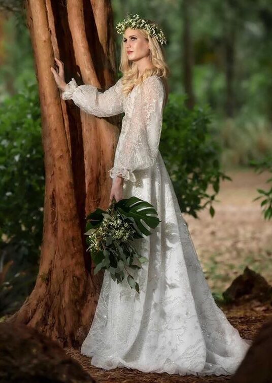 whimsical wedding dress, bride wearing a beautiful beaded gown in the garden near a tree in winter park florida