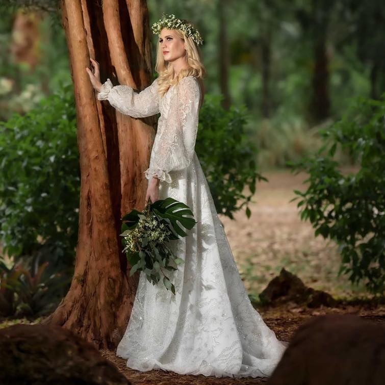 whimsical wedding dress, bride wearing a beautiful beaded gown in the garden near a tree in winter park florida