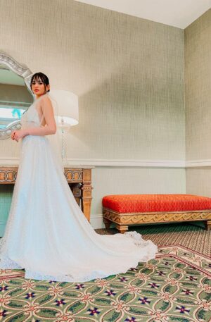 A bride in a Sparkly Glitter Wedding Dress is posing in front of a mirror.