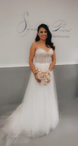 A bride wearing a tube-top wedding dress and holding a bouquet, version 2