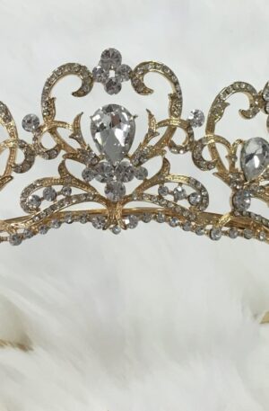 A gold tiara with crystals on it.