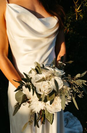 Wedding Dress Inspiration - A bride in a white dress holding a bouquet.
